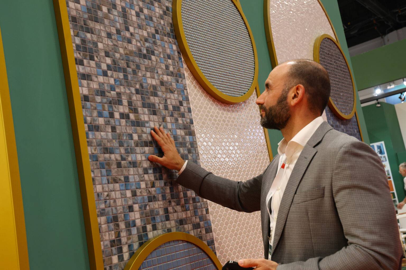 A man touches tiles at Coverings 2025