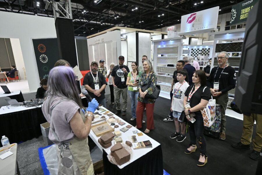 Artisan demonstrating handmade tile techniques at Coverings