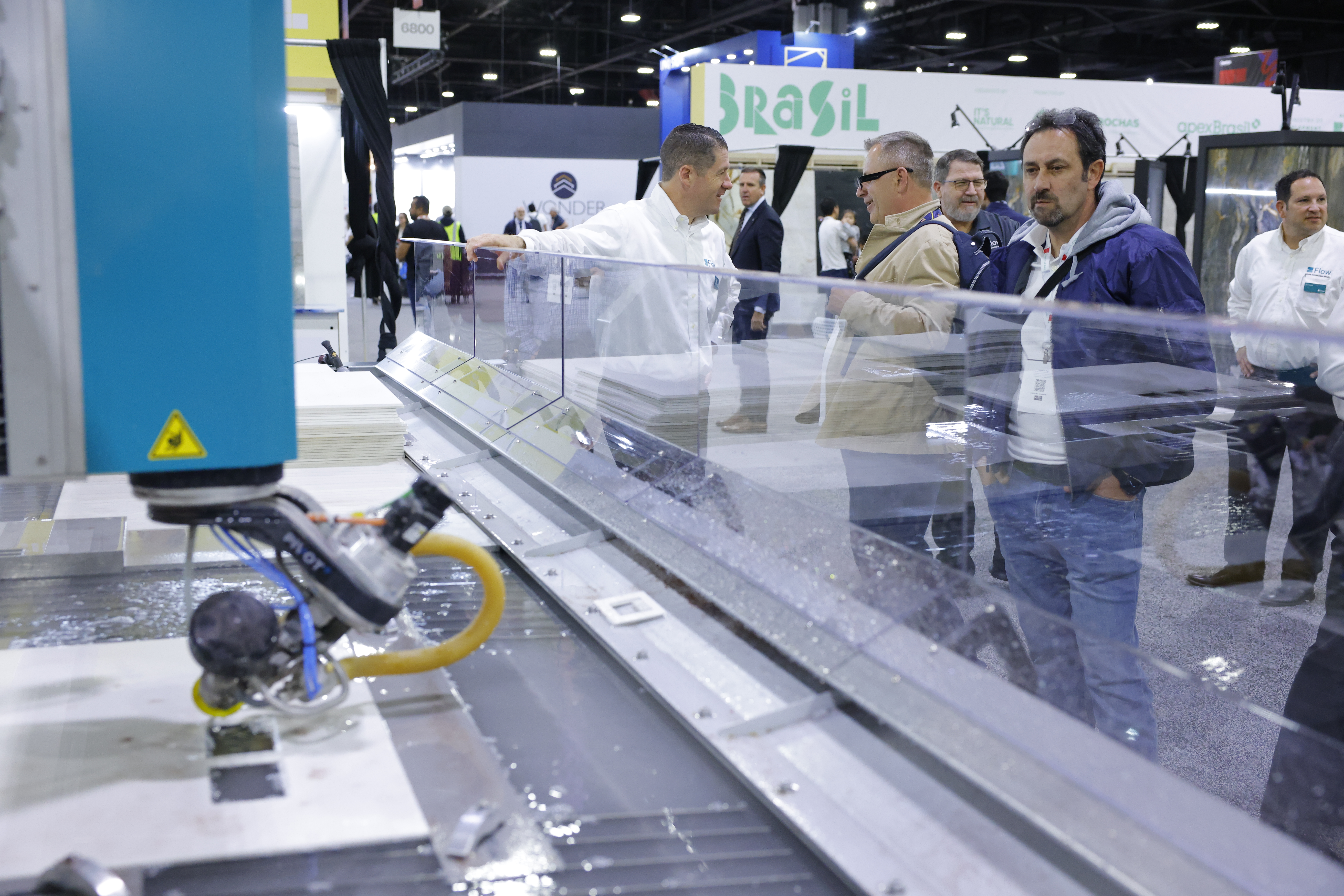 Installation professionals exploring tools and machinery at Coverings
