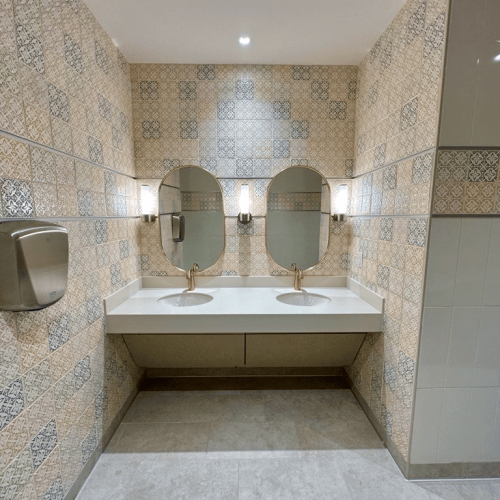 The restrooms and water fountains have a random pattern of decorative handmade 6x6 crackle finish tiles, in 18 different colors. All deco tiles were also of different thicknesses and sizes.